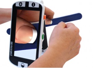 Person using the Pebble HD handheld magnifier to file finger nails.